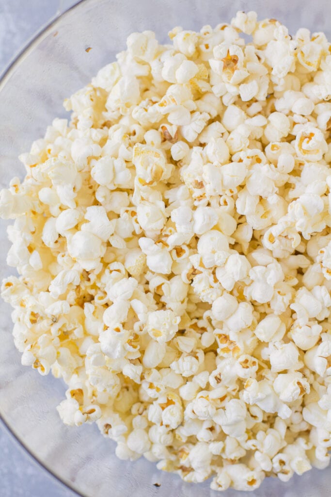 Popcorn air popped in a bowl about to be turned into chocolate covered popcorn.