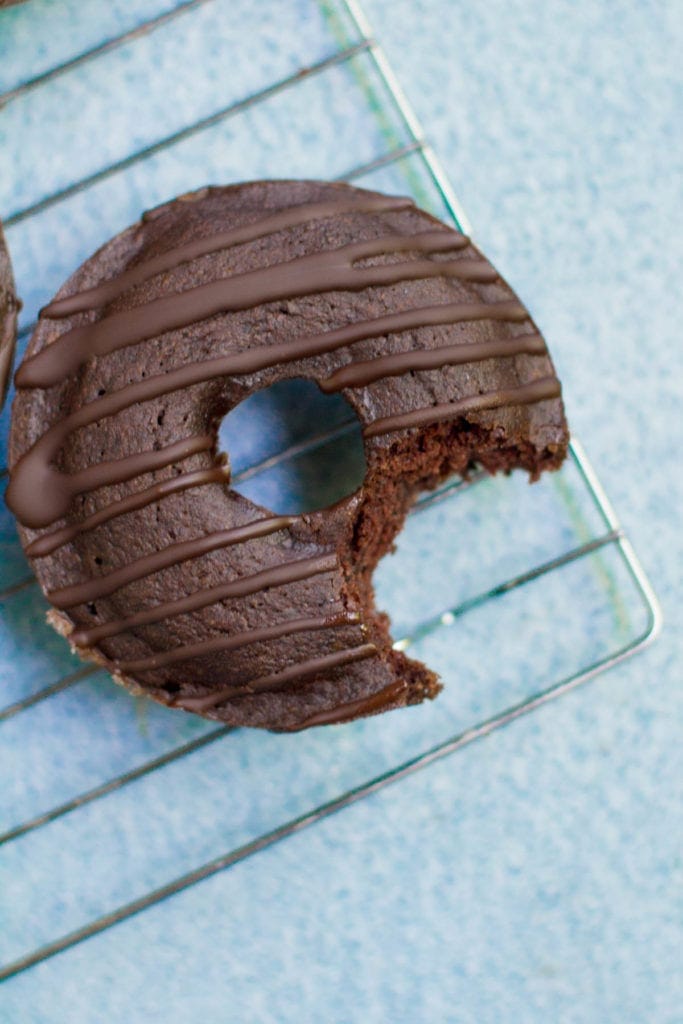 a healthy chocolate donut with a bite taken out of it