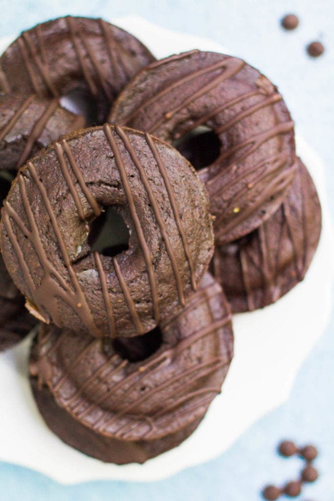 a white plate piled high with healthy chocolate donuts