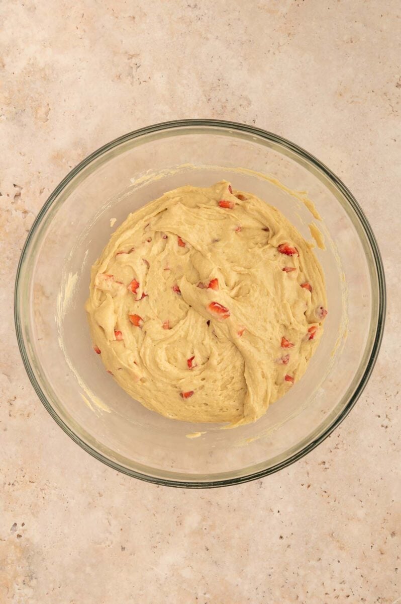 Strawberry protein muffin batter in a clear bowl. 