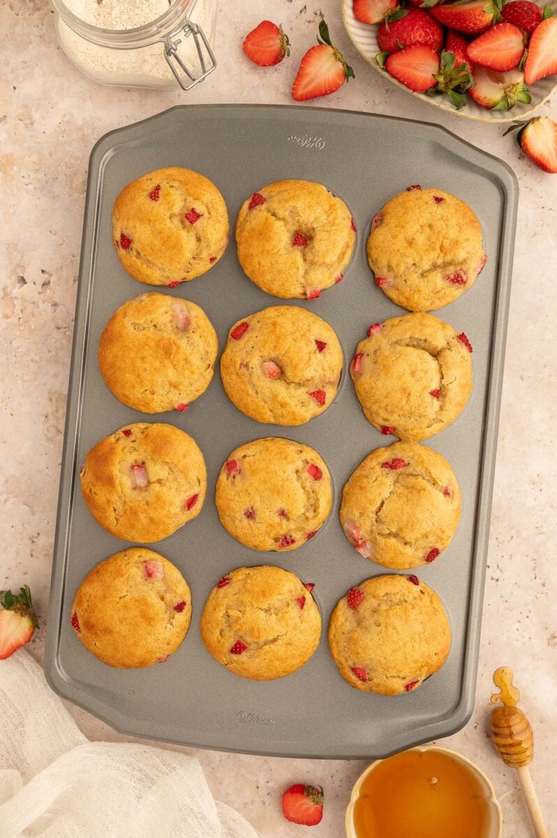 Strawberry protein muffins in a muffin tin.