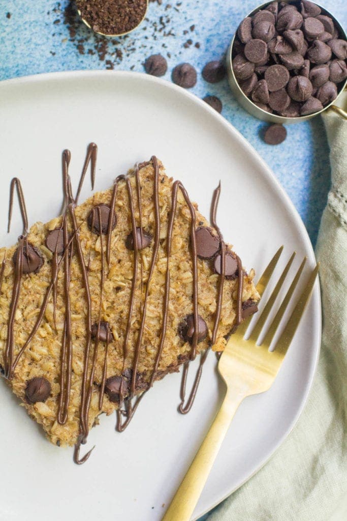 Healthy Chocolate Coffee Oatmeal on a white plate drizzled with chocolate. 