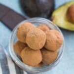 Healthy Chocolate Truffles in a small bowl on a blue background.