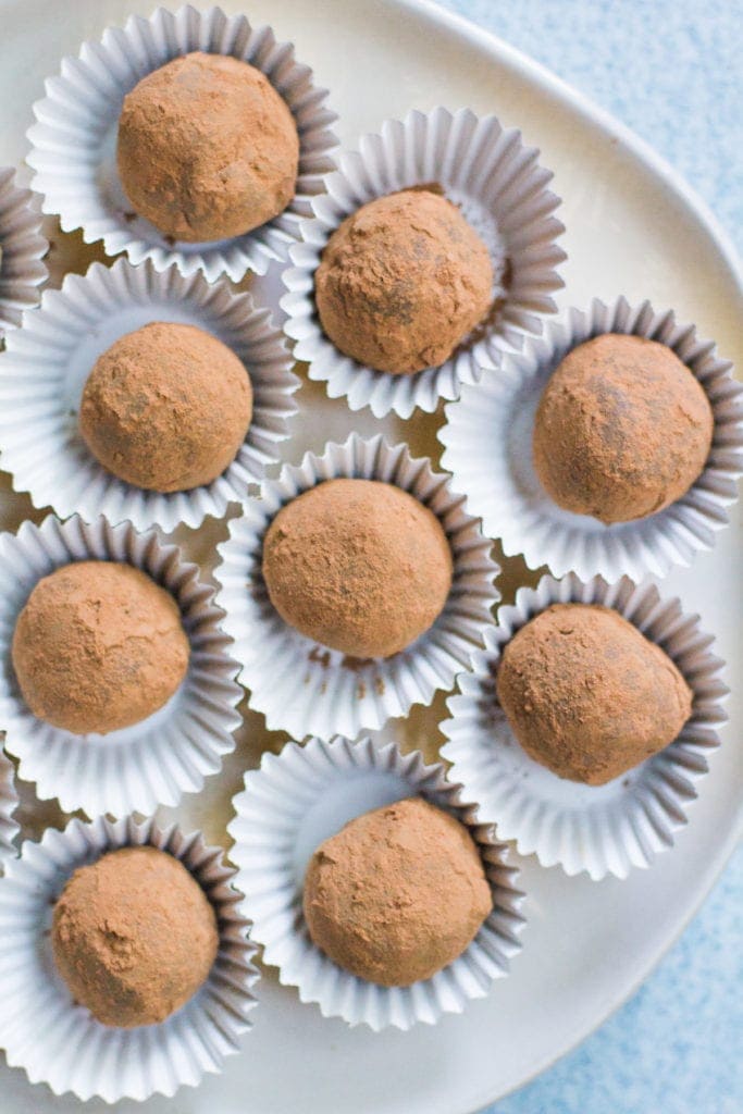 A plate of healthy chocolate truffles in wrappers.