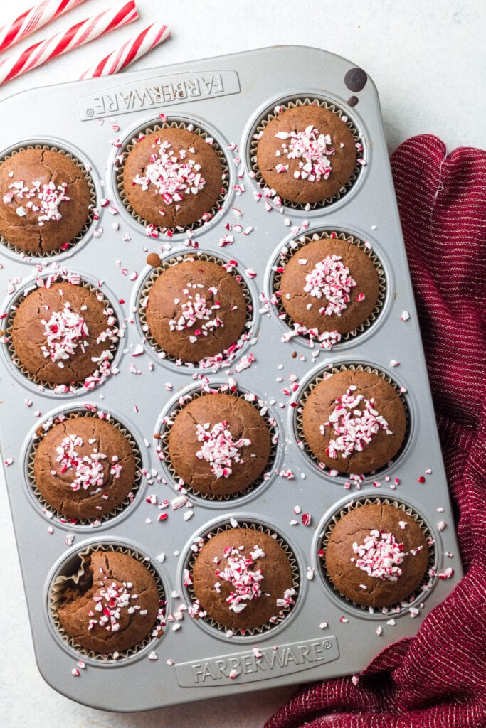 Healthy Peppermint Mocha Muffins in a muffin tin on a light background