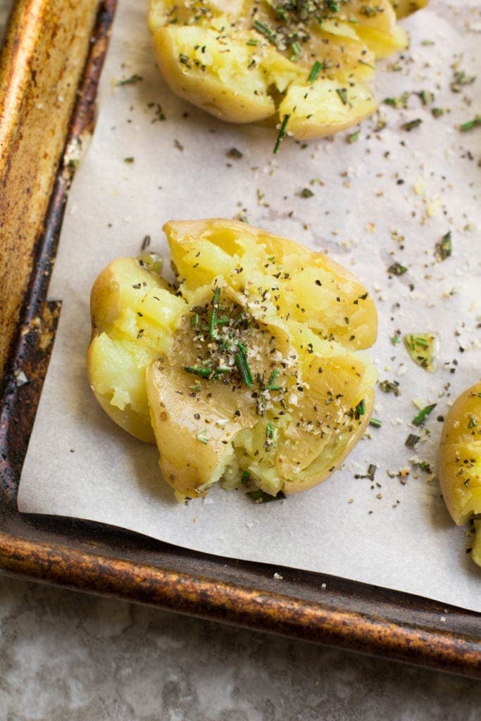 A close up of Crispy Smashed Potatoes on a baking sheet