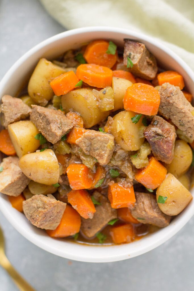 Paleo Beef Stew in a white bowl on a grey background