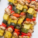 Pineapple Chicken Kabobs piled high on a white plate