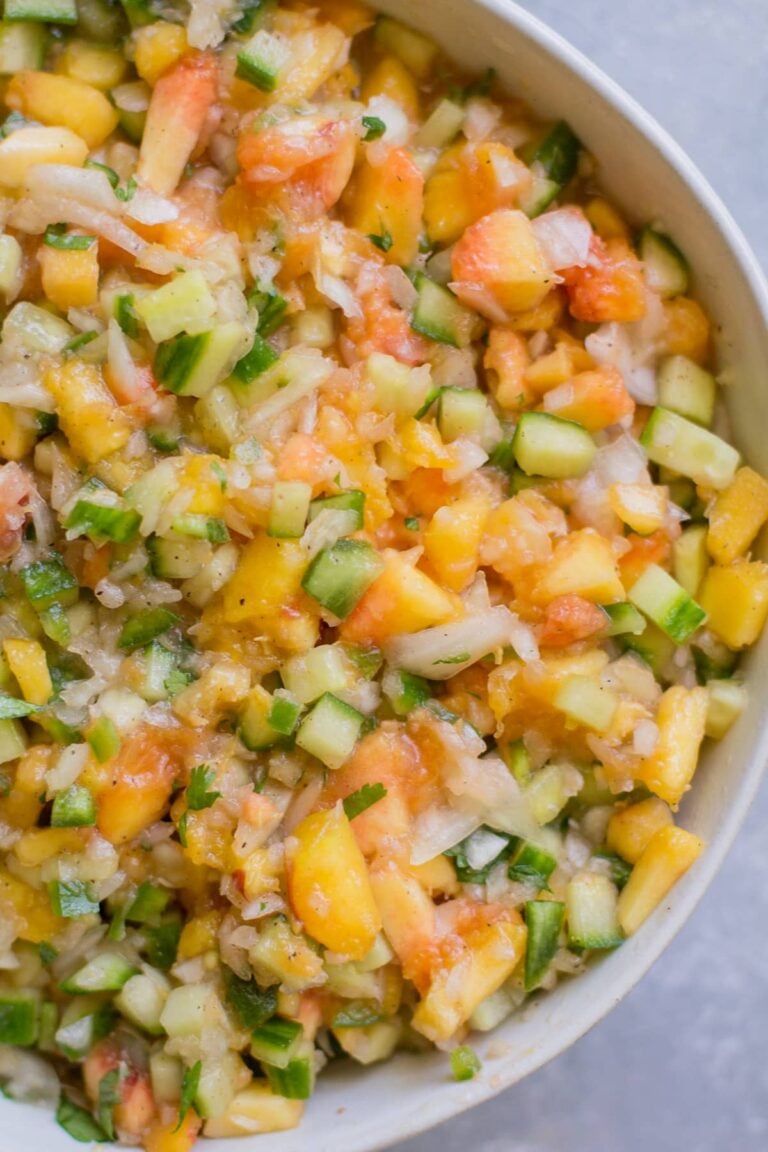 Healthy Peach Salsa in a white bowl on a grey background