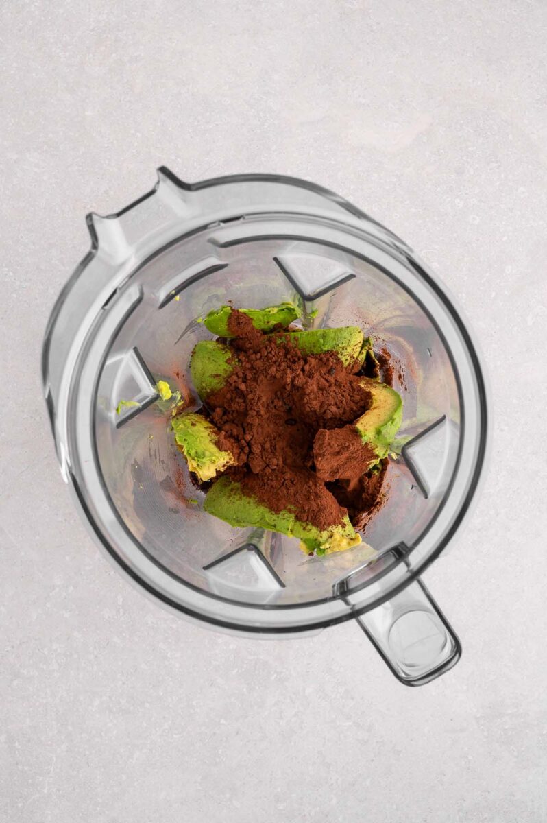 Ingredients for chocolate avocado pudding in a blender before blending.