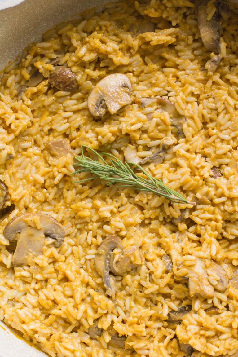 A close up of pumpkin mushroom risotto in a white pan
