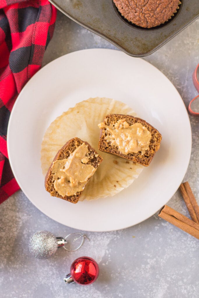 a gingerbread muffin cut in half and covered with nut butter.