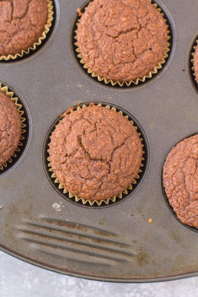 an overhead shot of gluten free gingerbread muffins in a muffin pan