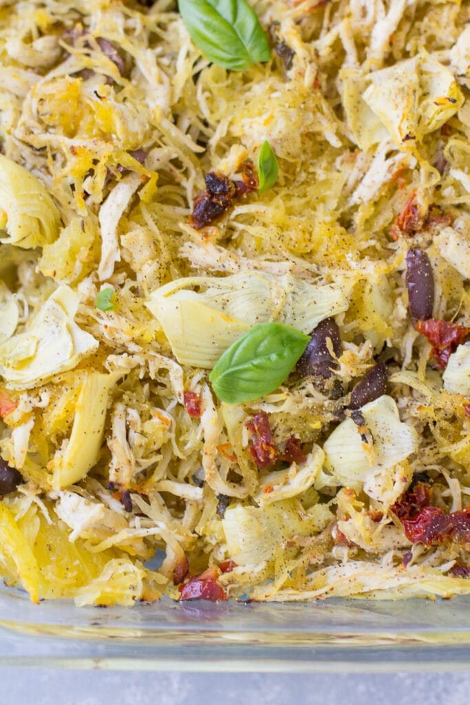 A glass baking dish fresh out of the oven filled with greek chicken spaghetti squash bake. 