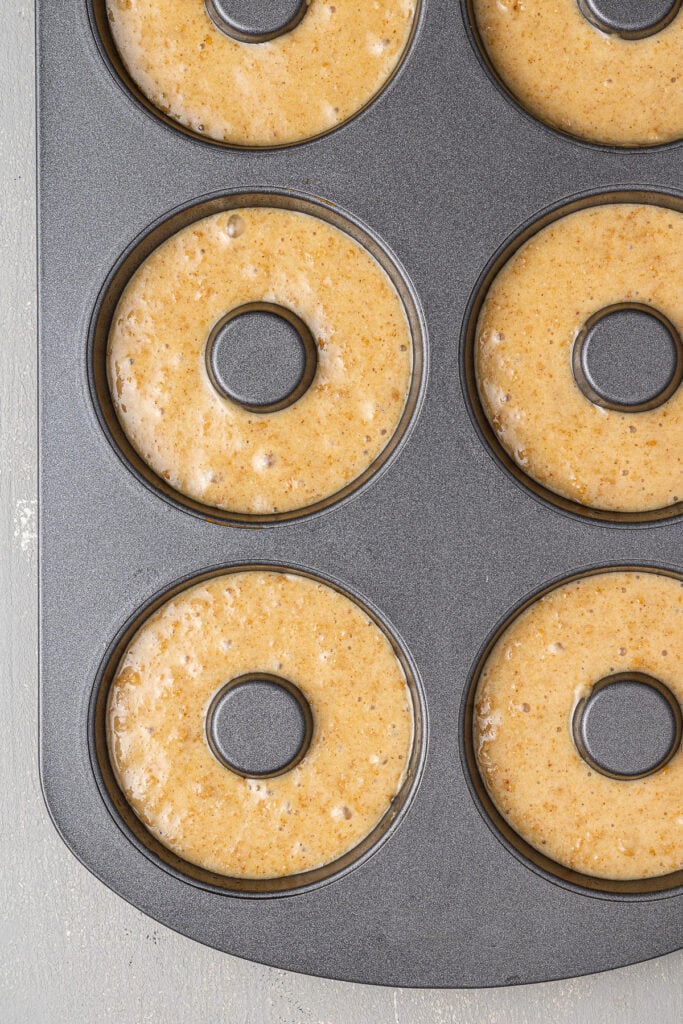 Protein donut batter in a donut pan, viewed from overhead.