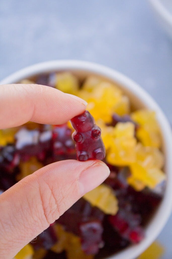 A hand holding up healthy gummy bears in their palm