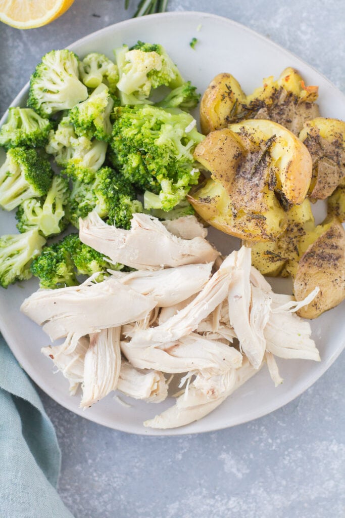 Crispy Smashed potatoes on a plate with chicken and broccoli