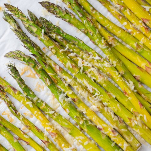 Healthy Lemon Parmesan Roasted Asparagus on a parchment lined baking sheet