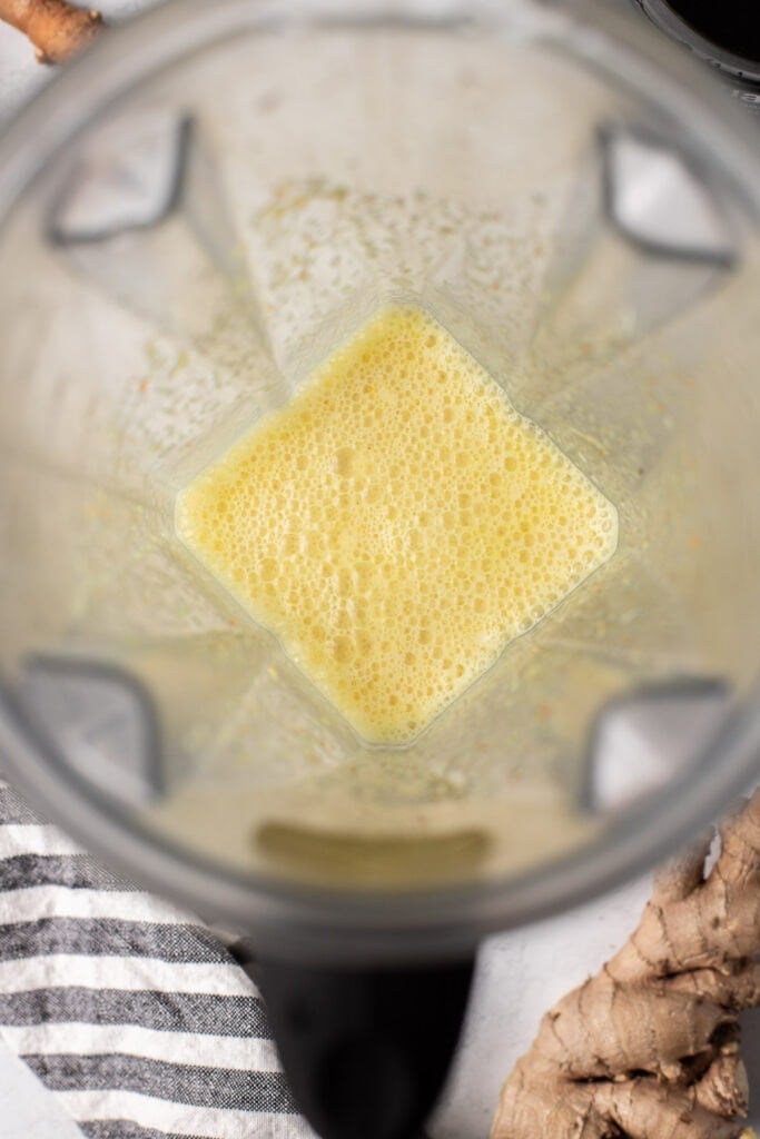 An overhead shot of a blender making a turmeric latte