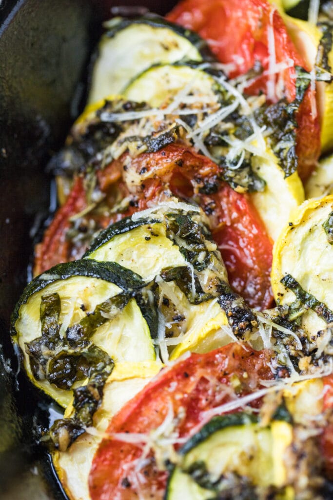 A close up of Zucchini Tomato Bake in a cast iron skillet