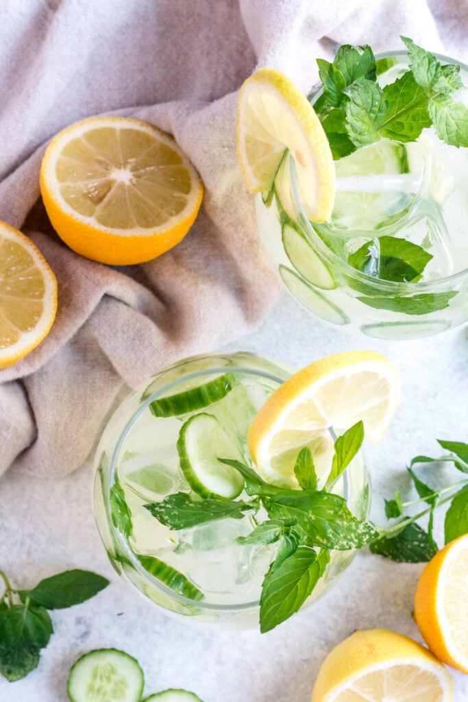 An overhead shot looking down into two cucumber cocktails