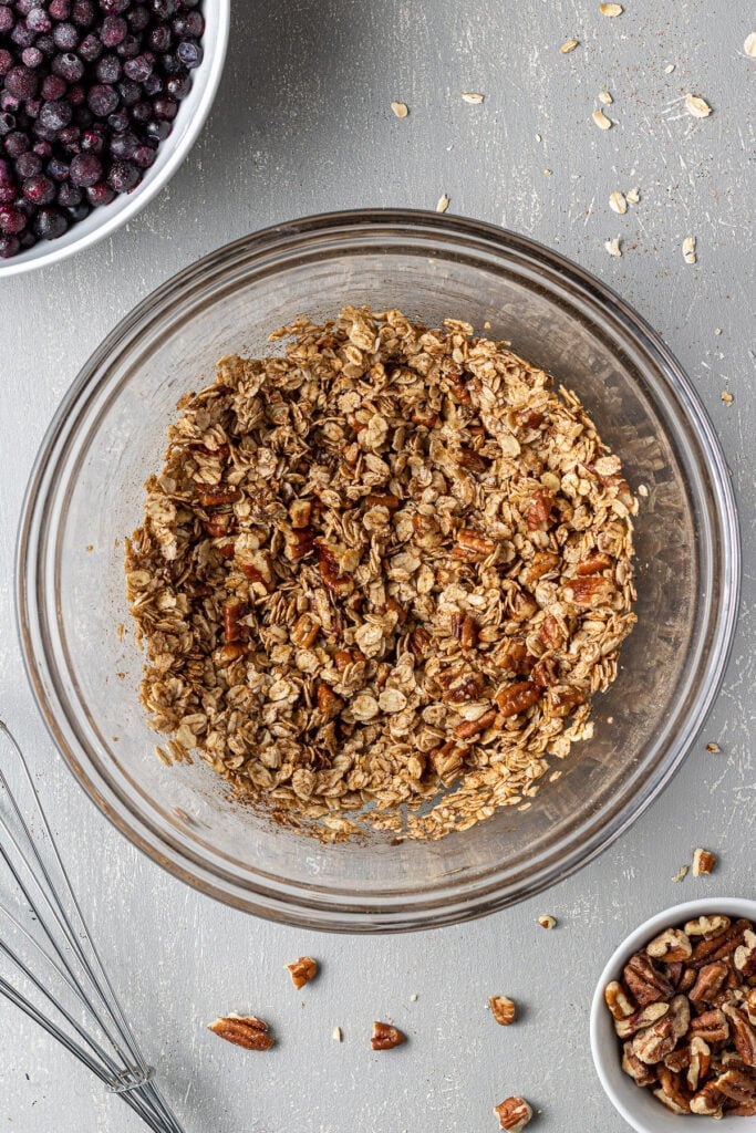 Healthy Crisp topping being whisked together in a white bowl.