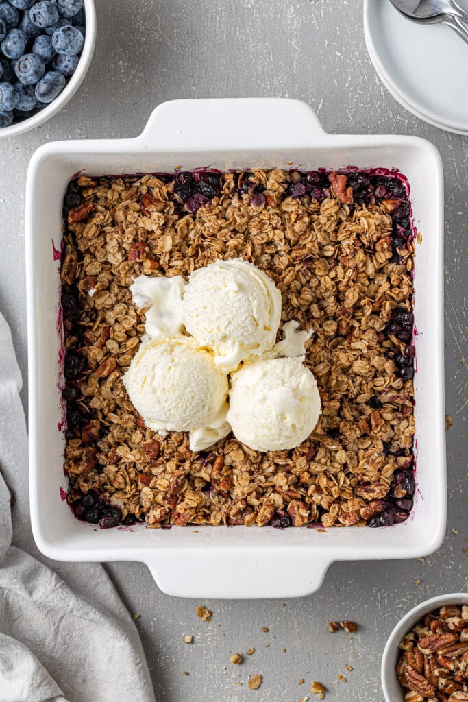Gluten Free Blueberry Crisp out of the oven in a white dish.