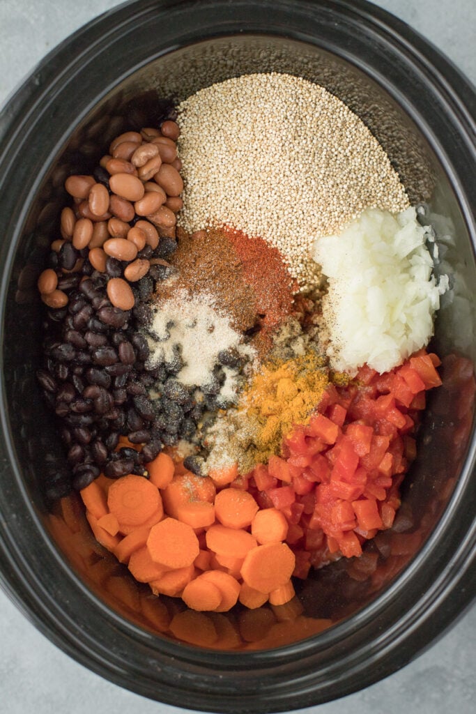 An overhead image of Chicken Quinoa Soup ingredients in a crockpot