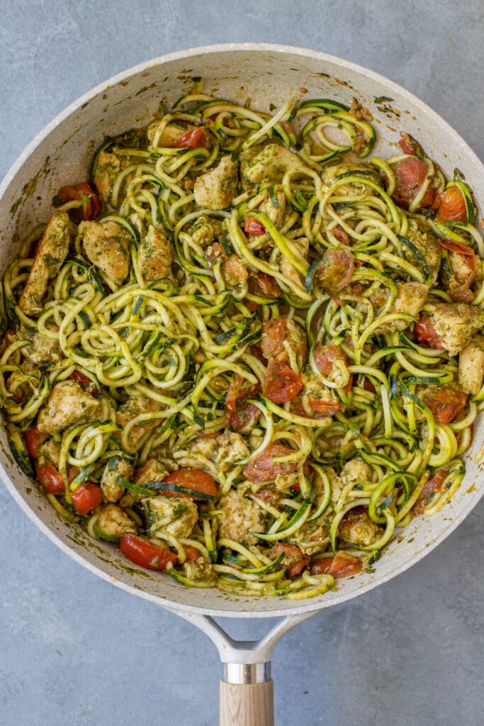 A close up of Pesto Chicken Pasta in a light grey pan.