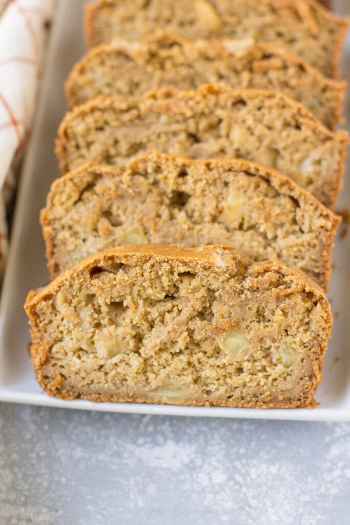 Apple Cider Bread slices on a white dish. Gluten free and naturally sweetened.