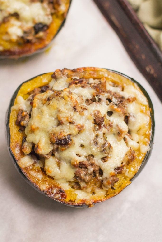 Beef Stuffed Acorn Squash on a parchment lined baking sheet.