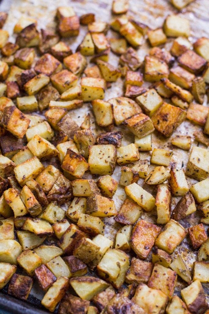Crispy Dijon Roasted Potatoes on a baking sheet lined with parchment paper