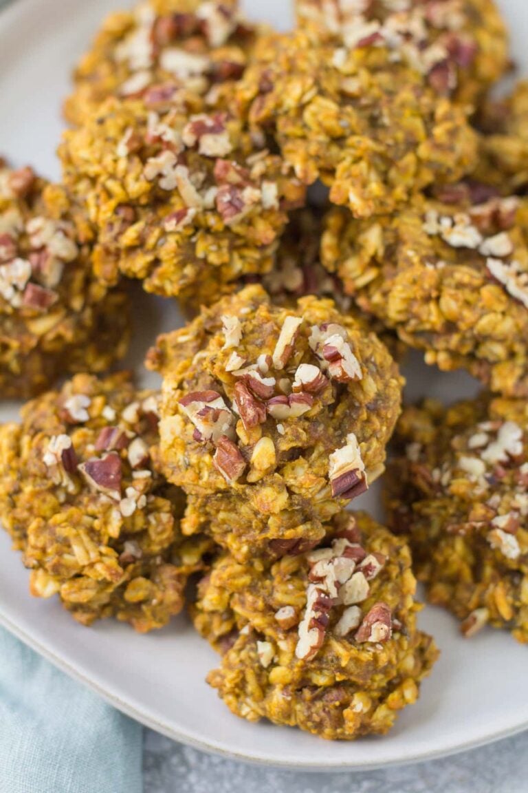 Healthy Pumpkin Breakfast Cookies on a white plate with a grey background and a blue linen in the back