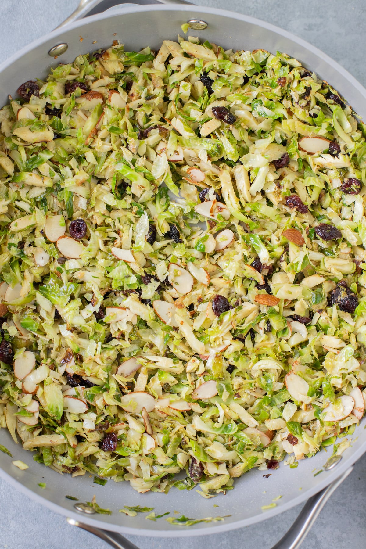 shaved brussel sprout salad in a pan after cooking and being mixed