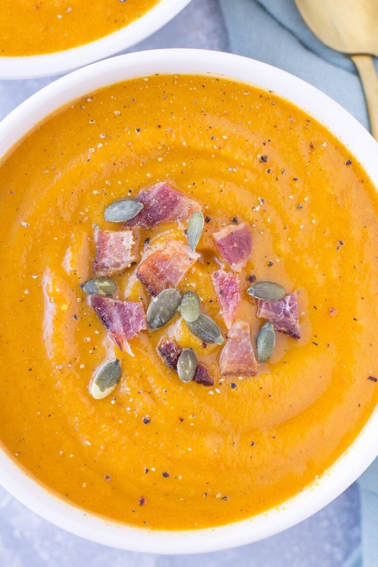 Healthy Butternut Squash Soup in a white bowl on a grey background.