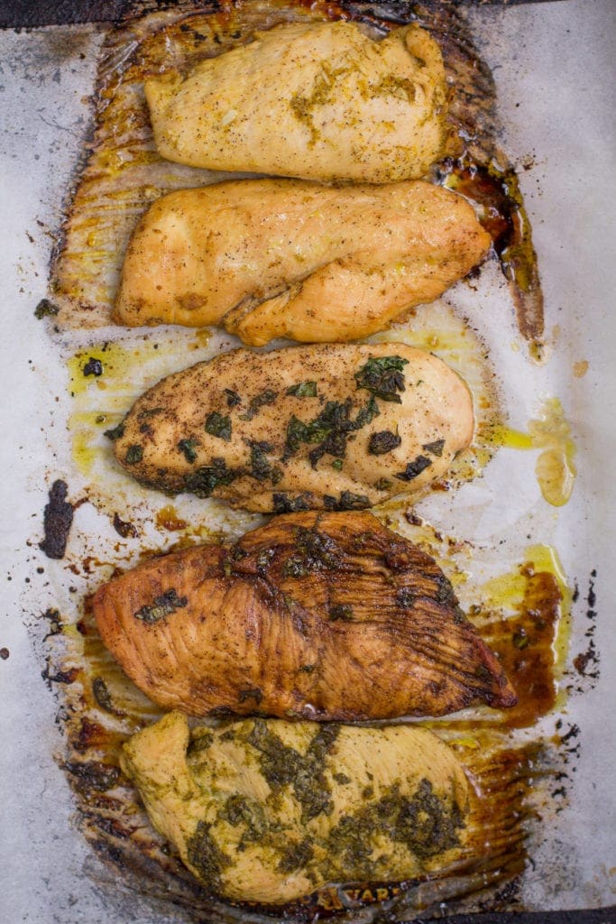 5 Healthy Chicken Marinades out of the oven, cooked on a parchment lined baking sheet