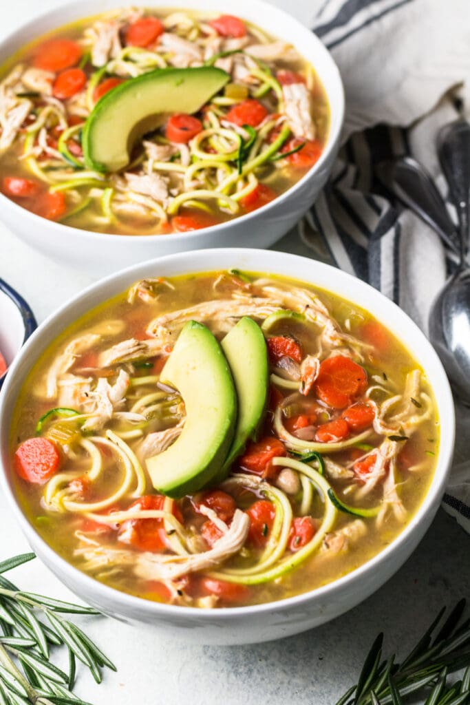 The best gluten free chicken noodle soup in a white bowl 