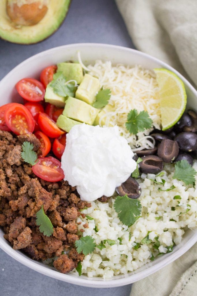 a close up image of keto taco cauliflower rice bowls.