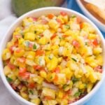 A white bowl filled with pineapple salsa, viewed from overhead.