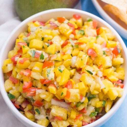 A white bowl filled with pineapple salsa, viewed from overhead.