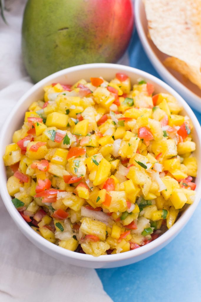 A white bowl filled with pineapple salsa, viewed from overhead.