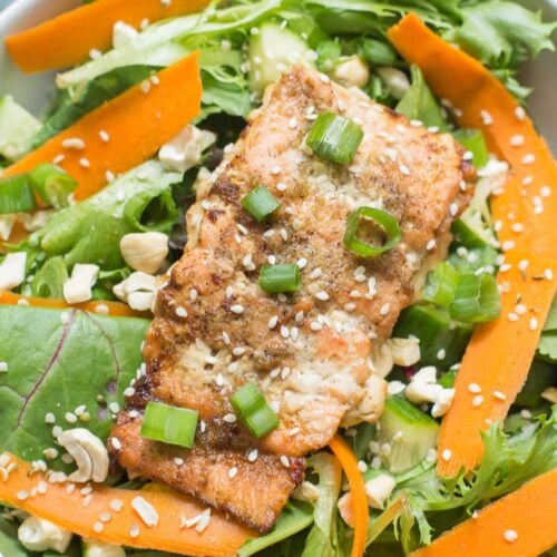 Asian salmon over a salad with carrots, cashews and sesame seeds