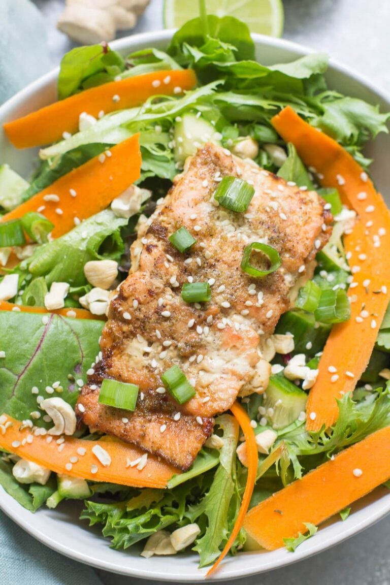 Asian salmon over a salad with carrots, cashews and sesame seeds