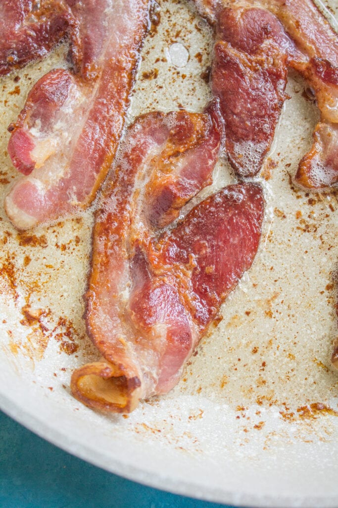 a close up of bacon being used in breakfast cauliflower fried rice
