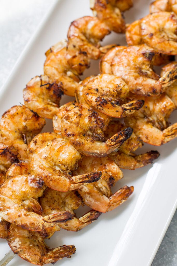 Close up of chili lime shrimp on a white square plate