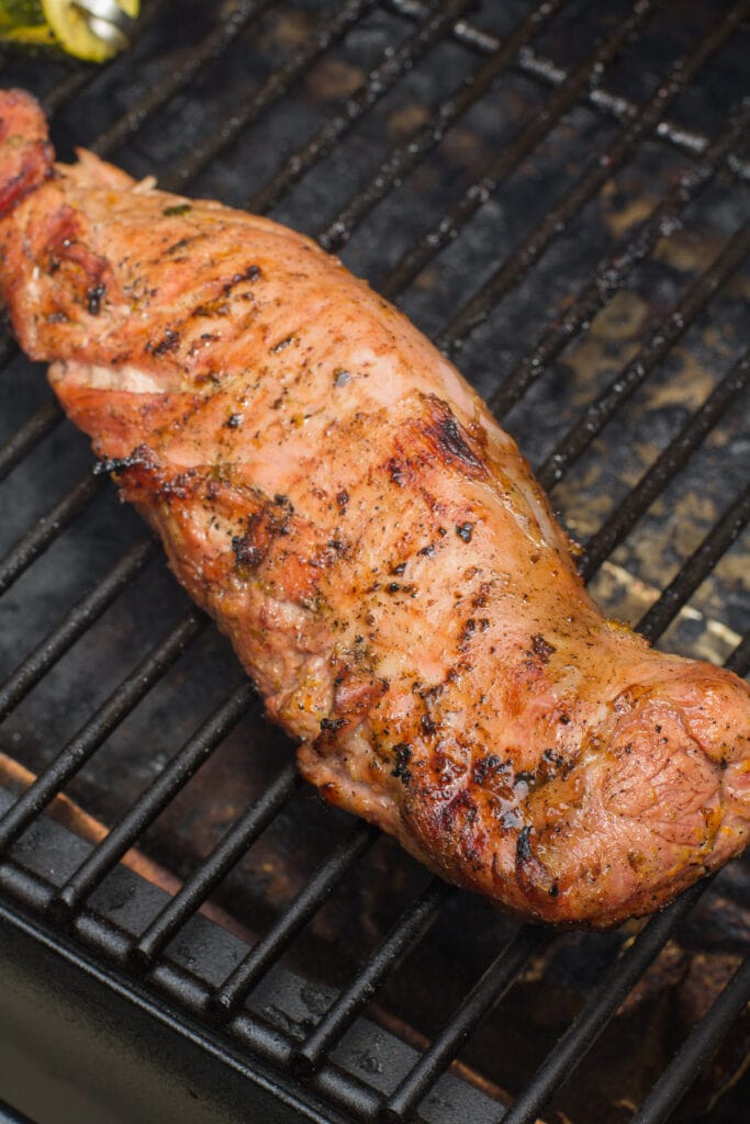 a close up of Citrus Grilled Pork Tenderloin on the grill