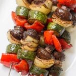 balsamic grilled vegetable kebabs on a white plate