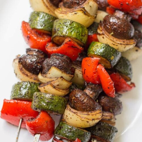 balsamic grilled vegetable kebabs on a white plate