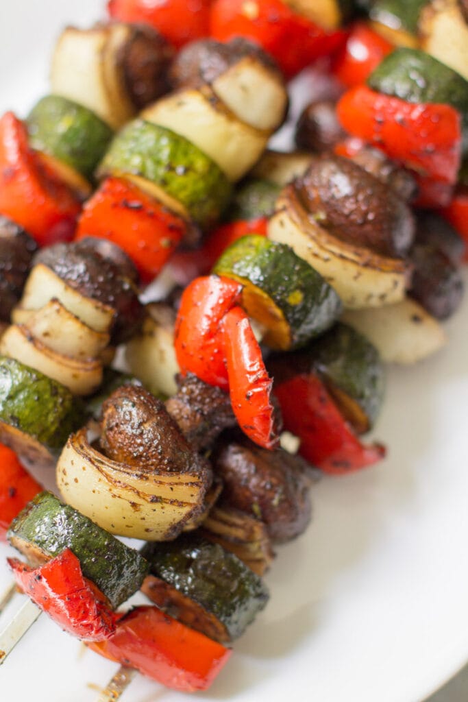 balsamic vegetable kebabs on a white platter