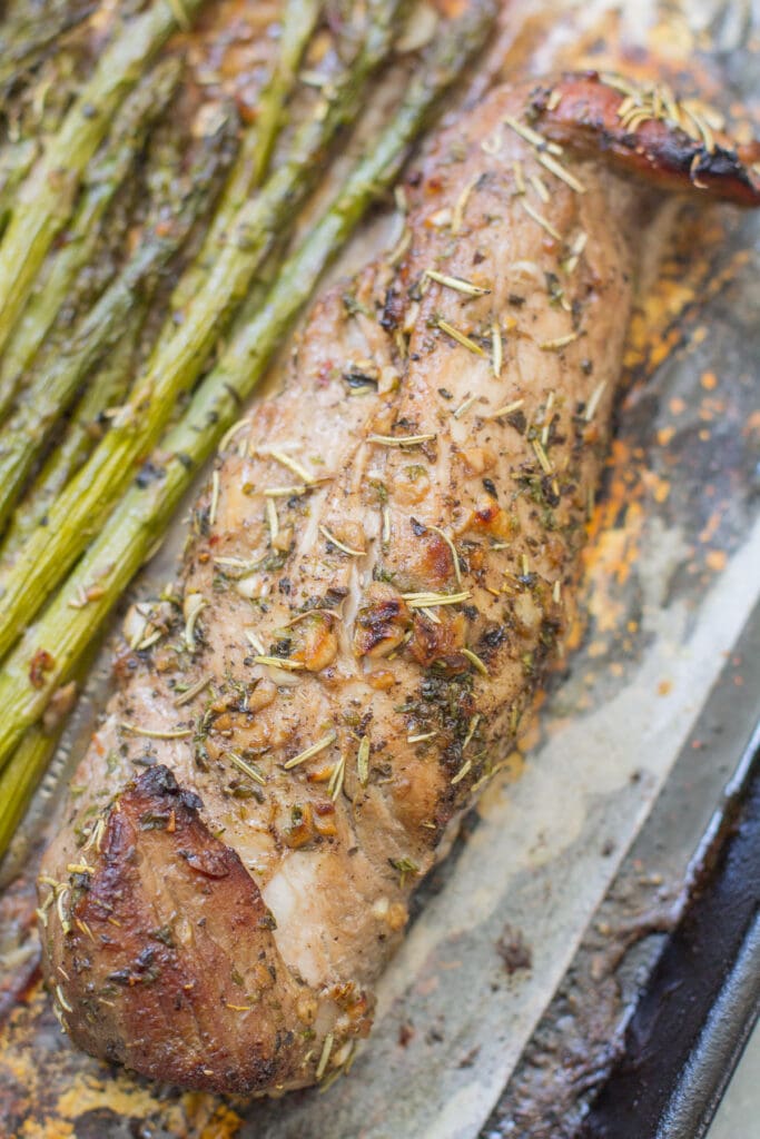 italian Sheet pan pork tenderloin - close up photo of pork tenderloin on baking sheet.